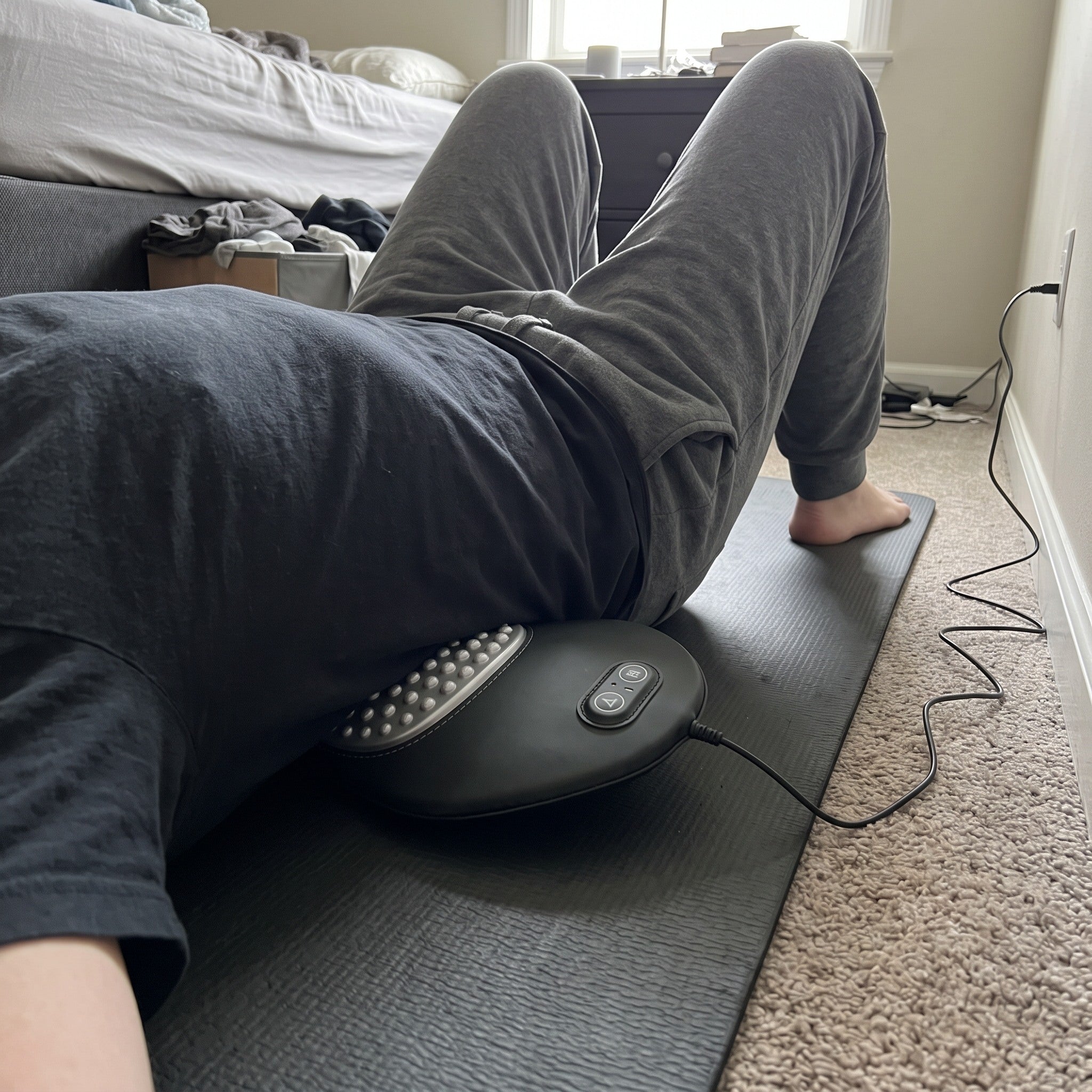 Easeback under the lower back on a bedroom mat